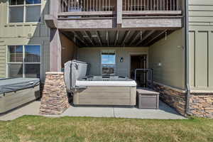View of patio with a hot tub