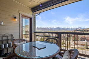 Balcony with outdoor dining area and a mountain view