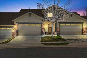 Craftsman house featuring concrete driveway, board and batten siding, and an attached garage