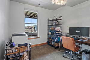 Office area featuring a notable chandelier, visible vents, baseboards, and carpet floors