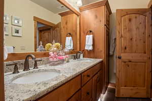 Bathroom featuring double vanity, visible vents, tile patterned flooring, and a sink