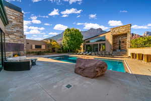 Swimming pool featuring a patio area and a mountain view