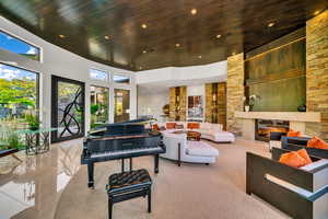 Building lobby featuring wood ceiling, recessed lighting, and a high ceiling