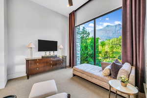 Carpeted living area with baseboards