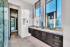 Full bathroom featuring a shower stall and plenty of natural light