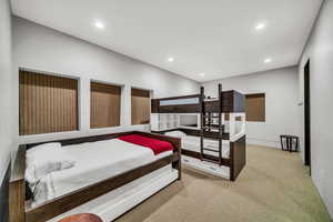 Bedroom with recessed lighting and light carpet