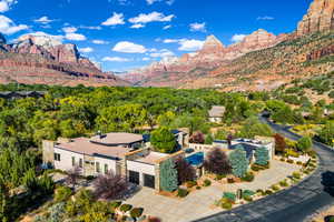 View from above of property featuring a forest and a mountainous background