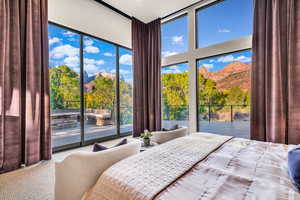 Carpeted bedroom featuring access to outside and a mountain view