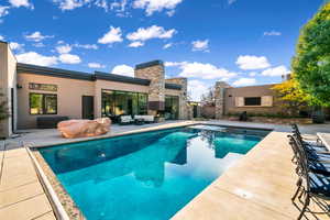 View of pool featuring an outdoor hangout area and a patio