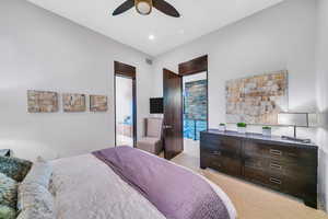 Bedroom with light colored carpet, a ceiling fan, and recessed lighting