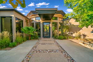 Entrance to property featuring stucco siding