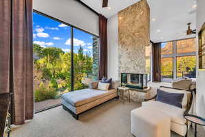 Sitting room featuring a ceiling fan, carpet flooring, a fireplace, and recessed lighting