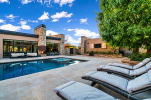 View of swimming pool with an outdoor hangout area, a patio, and a pool with connected hot tub