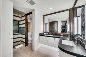 Bathroom featuring a stall shower, light tile patterned flooring, and recessed lighting