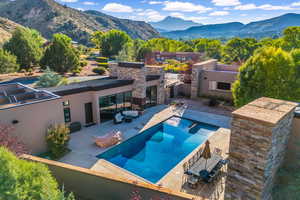 Outdoor pool with a patio and a mountain view