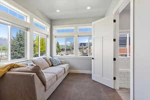 Cozy sitting area in the main bedroom, offering a peaceful retreat with plenty of natural light and a serene ambiance, perfect for relaxation or reading.
