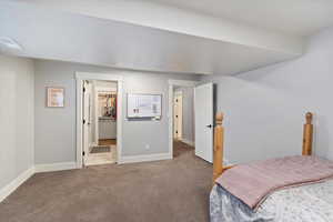 Private lower-level bedroom with ensuite bathroom, featuring a large walk-in closet for ample storage and a serene, comfortable retreat.