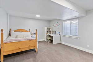 Private lower-level bedroom with an en suite bathroom, offering a quiet retreat with comfortable amenities and a peaceful atmosphere.