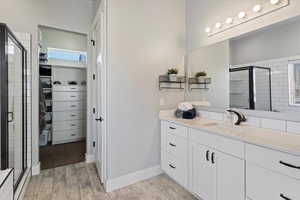 Luxurious main bathroom featuring a separate tub and tiled shower, along with a private toilet room for added convenience and privacy.