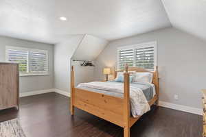 The sleeping zone comfortably fits a bed,  nightstand, and dressers with soft lighting and a calm ambiance.