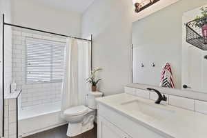 Sophisticated main floor full bathroom featuring subway tile, granite countertops, and a spacious linen closet.