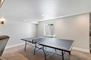 Family room with a designated rec area, ideal for games, entertainment, or relaxing. A flexible space that seamlessly combines comfort with fun.