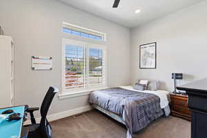 Main floor bedroom with high ceilings and large windows featuring elegant wooden shutters with a central adjustment mechanism. A serene space filled with natural light.