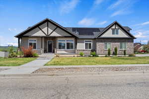 Stunning modern home located in the beautiful Mountain Green area, featuring a spacious front porch and energy-efficient solar panels, offering both style and sustainability.