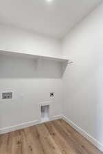Laundry room with hookup for an electric dryer, wood finished floors, washer hookup, and baseboards