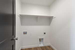 Laundry room with hookup for an electric dryer, wood finished floors, hookup for a washing machine, and baseboards
