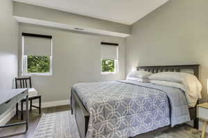 Bedroom with wood finished floors and baseboards