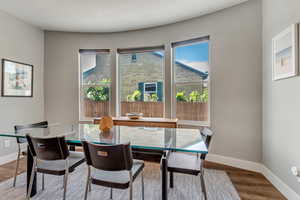 Dining room with wood finished floors and baseboards