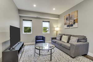 Living area featuring baseboards, wood finished floors, and recessed lighting