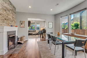 Dining area featuring wood-type flooring, a textured ceiling, and recessed lighting