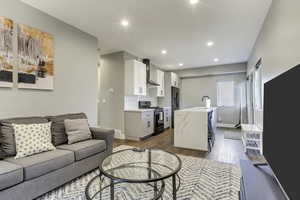 Living area featuring light wood finished floors, recessed lighting, and baseboards