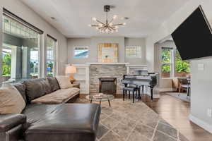 Living area featuring visible vents, plenty of natural light, wood finished floors, and a textured ceiling