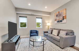 Living room with baseboards, recessed lighting, and wood finished floors