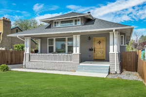 Bungalow with roof with shingles and covered porch