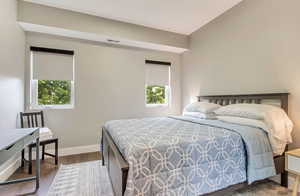 Bedroom featuring wood finished floors and baseboards