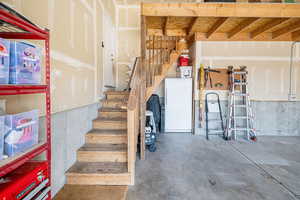 Stairway leading to main level with concrete floors