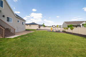 View of yard featuring a playground, stairway, and a residential view