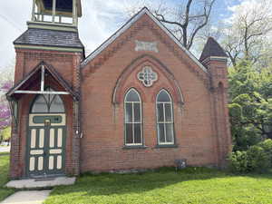 View of front of house with brick siding and a front lawn