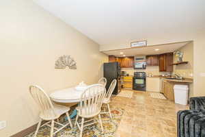 ADU Dining room featuring light stone finish floors and recessed lighting
