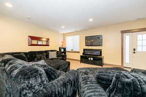 Carpeted living room featuring baseboards and recessed lighting