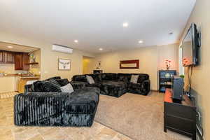 ADU Living area with a wall mounted air conditioner, recessed lighting, and wet bar