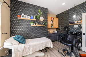 Office/Salon featuring wood finished floors, tile walls, an accent wall, and recessed lighting