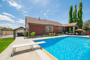 View of swimming pool with a patio, a gazebo, a diving board, and fence