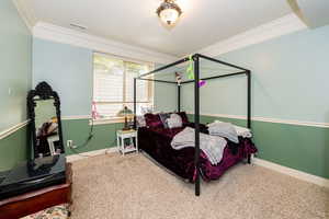 ADU Bedroom 1 featuring ornamental molding, carpet floors, and baseboards