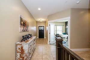 Entrance foyer with baseboards, light tile patterned floors, and recessed lighting