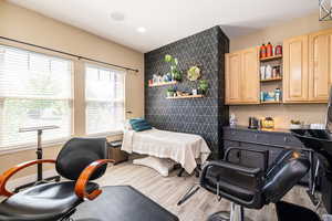 Office/Salon featuring wood finished floors, tile walls, and recessed lighting.